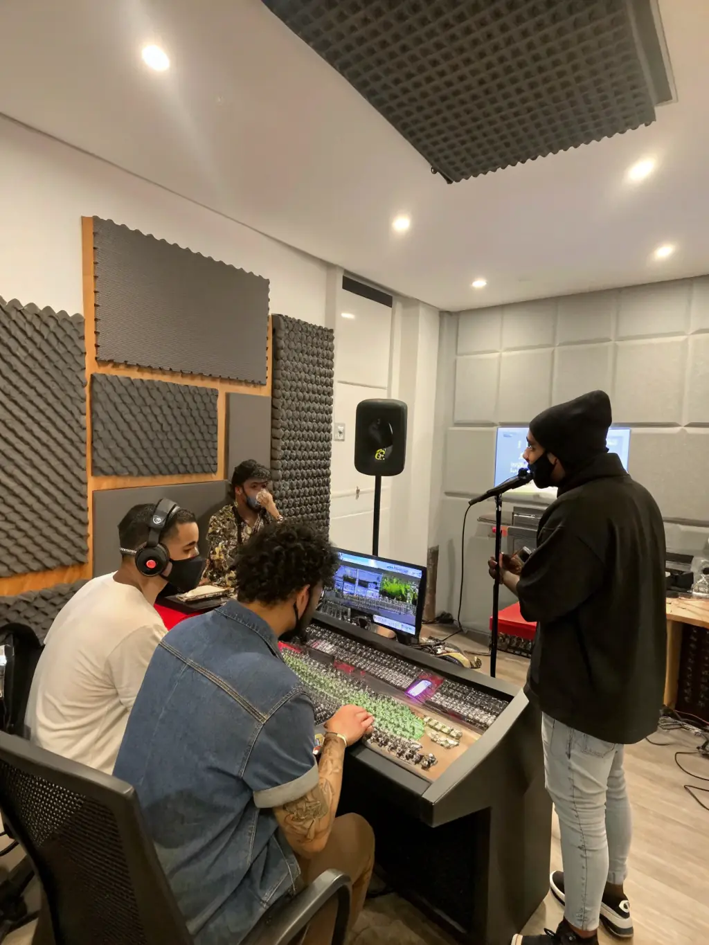 An image of artists engaged in a hands-on sound mixing workshop, with audio equipment and creative setups in a vibrant studio environment.